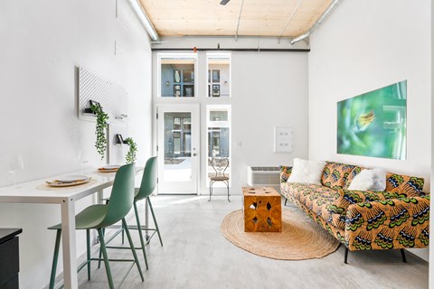 a living room with a couch and a table with chairs